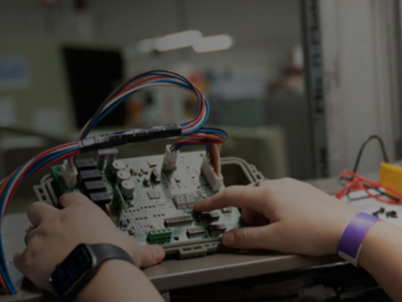 Close up on a person's hands working on a device